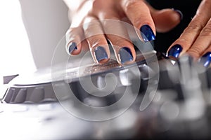 Female DeeJay hands on a DJ modern console