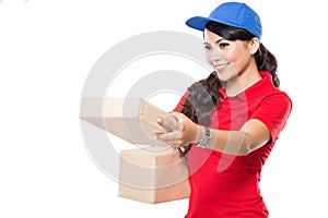 Female delivery service happily delivering package to costumer