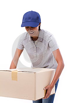 Female delivery staff carrying heavy carton box