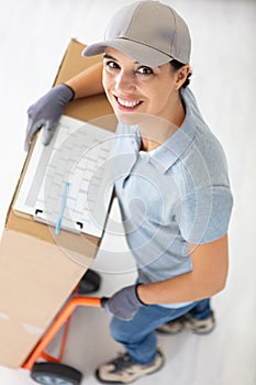 female delivery worker with hand truck