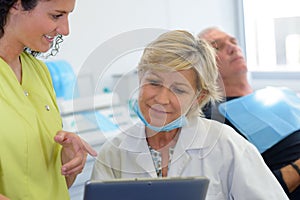 female dentist assistant and patient in dental practice