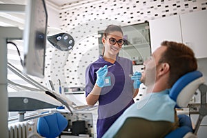 Female dentist beginning work with patient