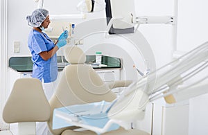 Female dentist checking and arranging tools in dental office