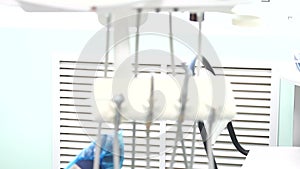 Female dentist checking up patient teeth