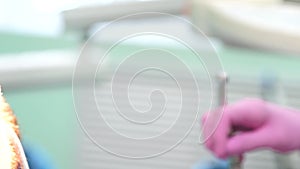 Female dentist checking up patient teeth