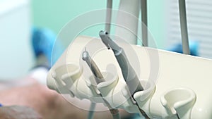 Female dentist checking up patient teeth