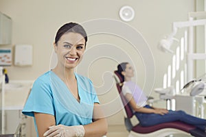 Female dentist in a dental office on the background of dental accessories.