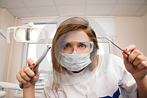 Female dentist with dental tools