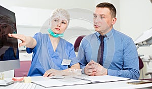 Female dentist discussing treatment with patient