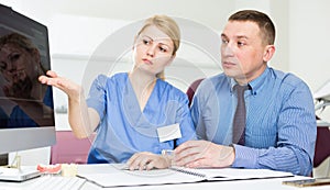 Female dentist discussing treatment with patient