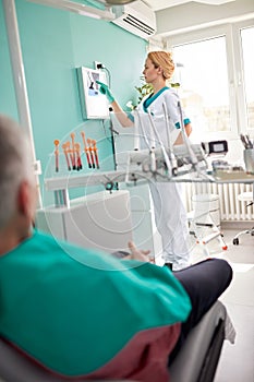 Female dentist examining dental X-ray