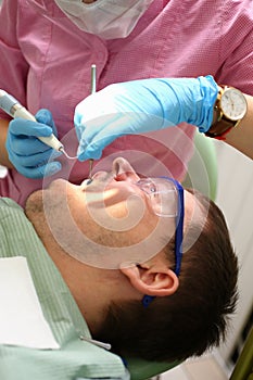 Female dentist examining patient teeth in dental clinic