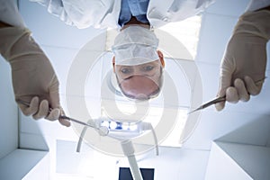 Female dentist holding dental tools