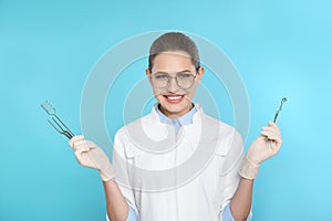 Female dentist holding professional tools