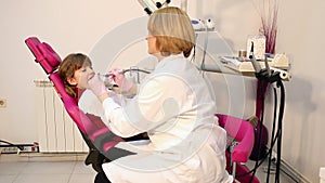 Female dentist and little girl