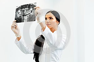 Female Dentist Looking at Dental Xray in Clinic