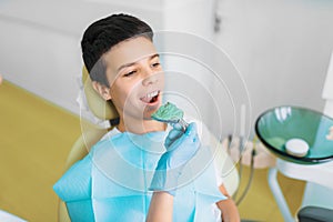 Female dentist makes teeth impression