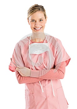 Female Dentist With Mirror And Probe Standing Arms Crossed