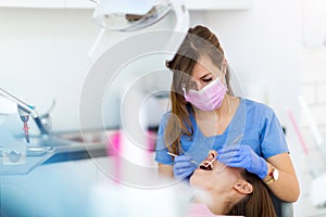 Dentist and patient in dentist office photo
