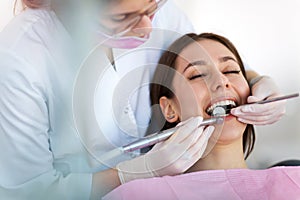 Dentist and patient in dentist office photo