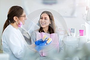 Dentist and patient in dentist office photo