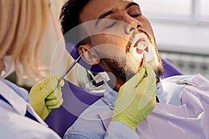 Female Dentist Performing Examination