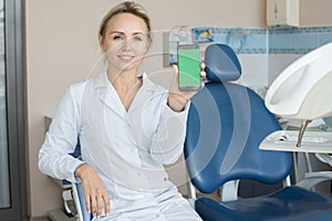 Female Dentist Presenting Mobile App