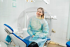 A female dentist sits in her dental office after work