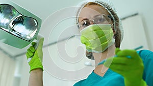 Female dentist wearing protection glasses, attention, professional services