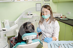 Female dentist working at dental clinic with female patien