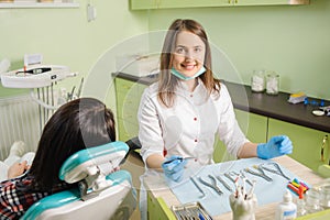 Female dentist working at dental clinic with female patien