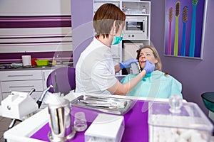 Female dentist working at her patients