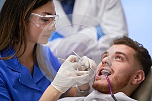 Female dentist working on her patientâ€™s teeth