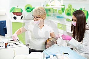 Female dentist working on a male patient using a cofferdam