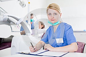 Female dentist working with medical records