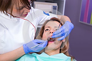 Female dentist and young female patient