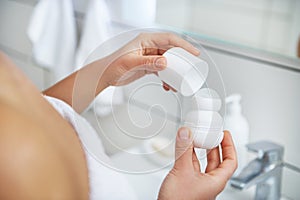 Female deodorant in hand. Roll-on antiperspirant . Close-up