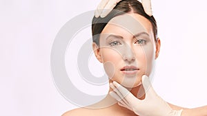 Female derma rejuvenate treatment. Doctor in gloves touch woman face. Cosmetology pretty portrait. Facial injection patient