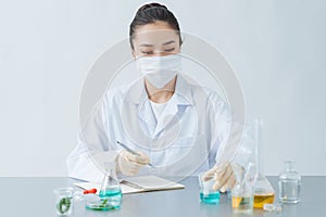 Female dermatologist doing research for new skin care product at table, closeup