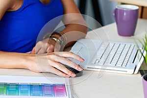 Female designer hands working with laptop computer