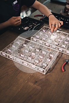 Female designer making jewelries at a jewelry shop o