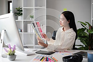 Female designer working in graphic design Choose colors for working on tablets and computer designs.