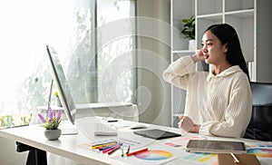 Female designer working in graphic design Choose colors for working on tablets and computer designs.