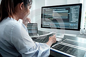 Female Developer programmer working on coding program software computer, Writing website and development database technology in