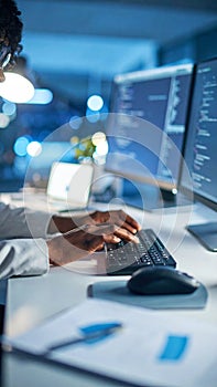 Female Developer Typing Code on Computer at Night in Modern Office