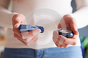 Female Diabetic Checking Blood Sugar Levels photo