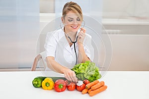 Female dietician examining vegetables