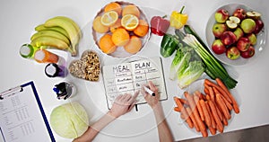 Female Dietitian Doctor Writing Meal Plan