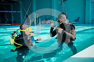Female diver and male divemaster, diving school