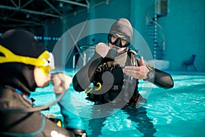 Female diver and male divemaster, diving school